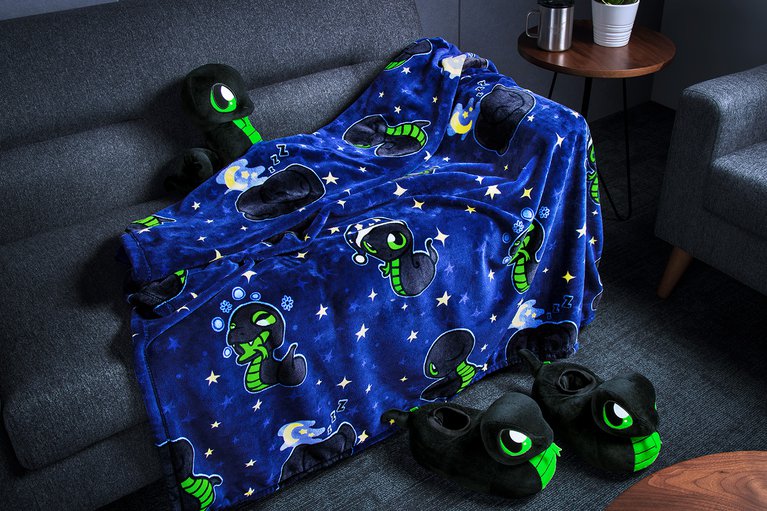 Razer Sneki Snek Fleece Blanket placed on sofa to showcase fabric texture and weight