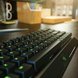 Razer BlackWidow V3 Mini Hyperspeed (Yellow Switch) US Key Closeup - Razer Home Workstation Warm (Angled View)