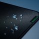 Razer Strider XXL Razer Tag Closeup with Water Droplets Liquid Resistant - Silver Surface with Light